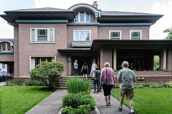 Guests walk into the Ashley C. and Cora W. Smith House 