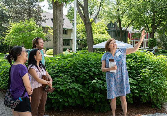 Guests listen to interpretation outside the home